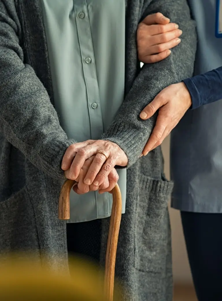 Starszy człowiek podpierający się laską
